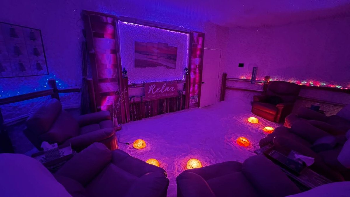 Salt cave recliners arranged around the Relax wall at Salinair Salt Room Spa
